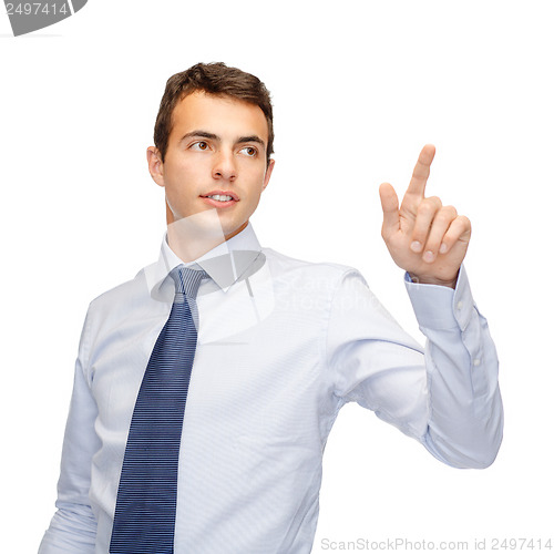 Image of businessman working with imaginary virtual screen