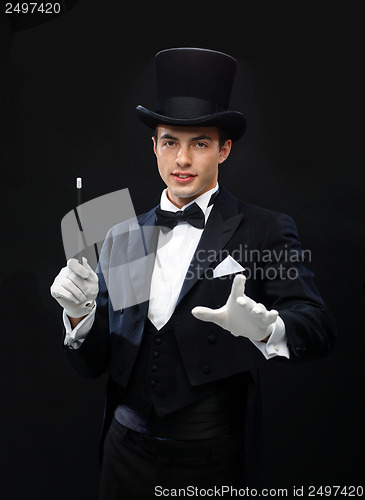 Image of magician in top hat with magic wand showing trick