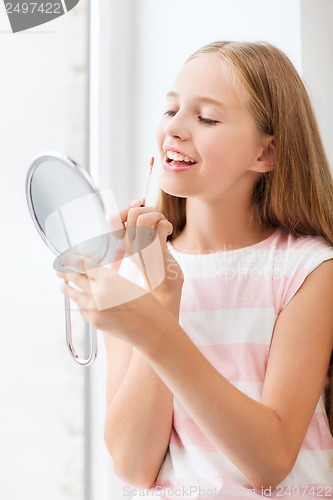 Image of teenage girl with lip gloss and mirror