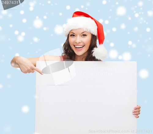 Image of woman in santa helper hat with blank white board