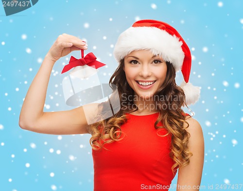 Image of woman in santa helper hat with jingle bells