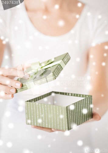 Image of woman hands with gift box