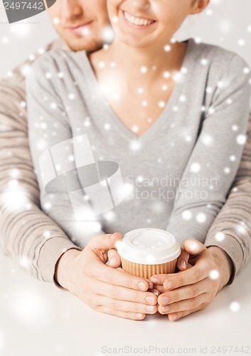 Image of woman and man with take away coffee cup