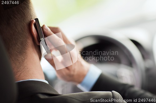 Image of man using phone while driving the car