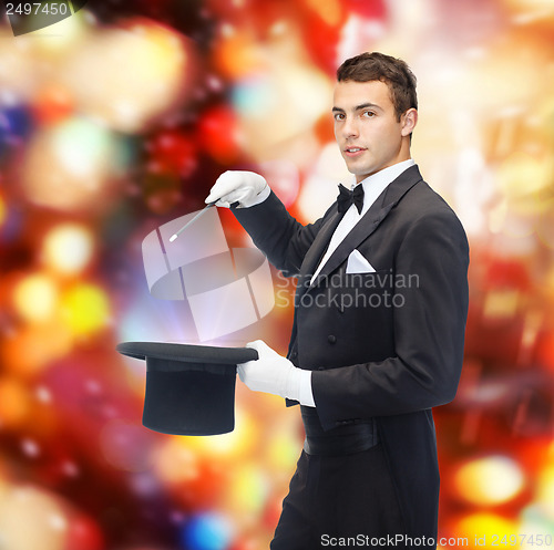 Image of magician in top hat with magic wand showing trick