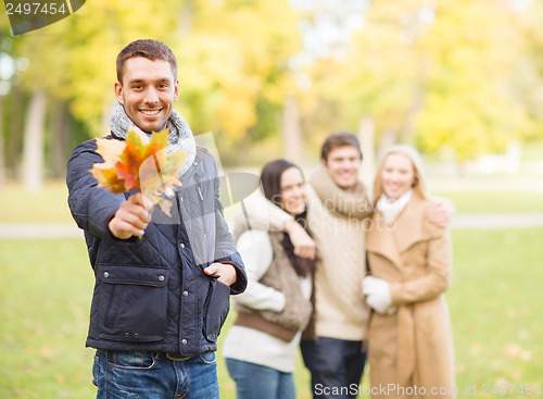 Image of group of friends having fun in autumn park