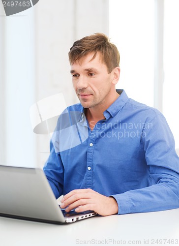 Image of man working with laptop at home