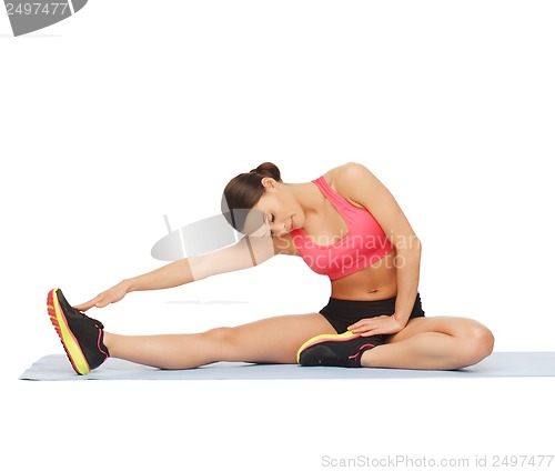 Image of sporty woman doing exercise on the floor