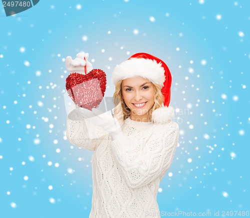 Image of smiling woman in santa helper hat with red heart