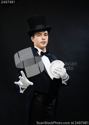 Image of magician showing trick with playing cards