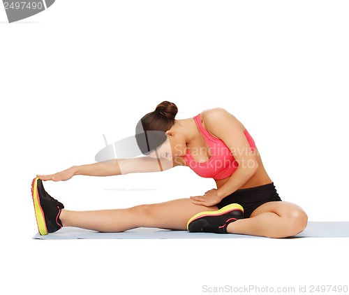 Image of sporty woman doing exercise on the floor