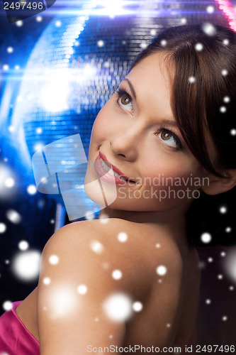 Image of woman in evening dress wearing diamond earrings