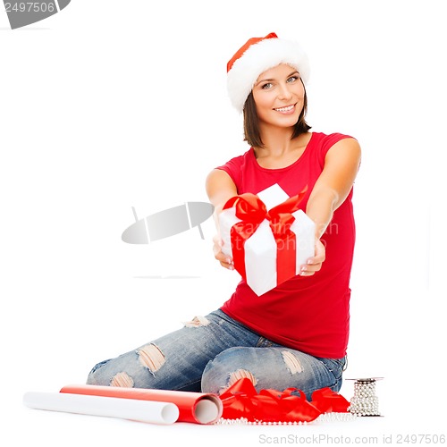 Image of smiling woman in santa helper hat with gift box