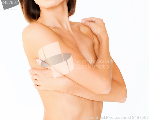 Image of woman with perfect skin and hands over breast