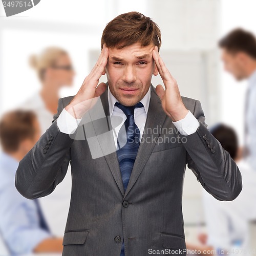 Image of stressed buisnessman or teacher having headache