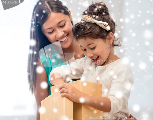 Image of happy mother and child girl with gift box