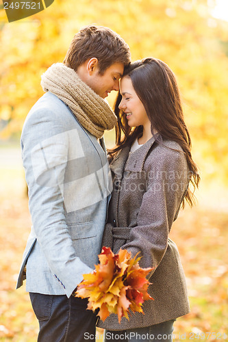 Image of romantic couple kissing in the autumn park