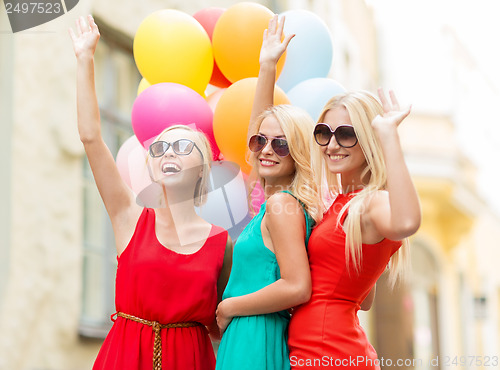 Image of beautiful girls with colorful balloons in the city