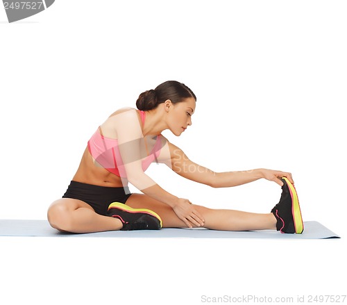 Image of sporty woman doing exercise on the floor