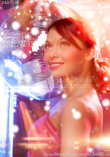 Image of woman in evening dress wearing diamond earrings