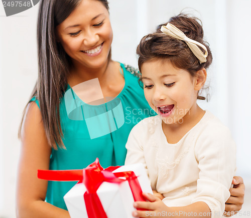 Image of happy mother and child girl with gift box