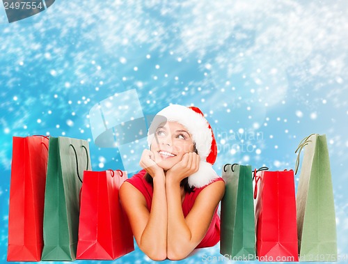 Image of woman in red shirt with shopping bags