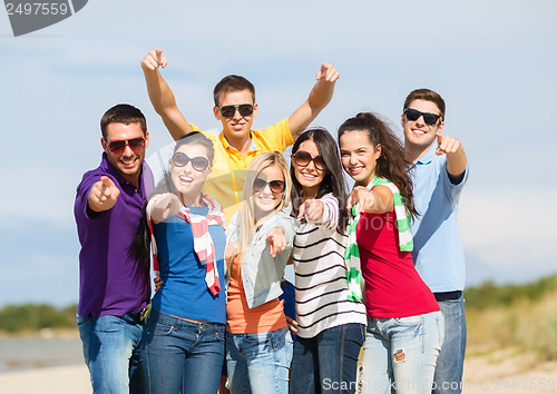 Image of group of friends having fun on the beach