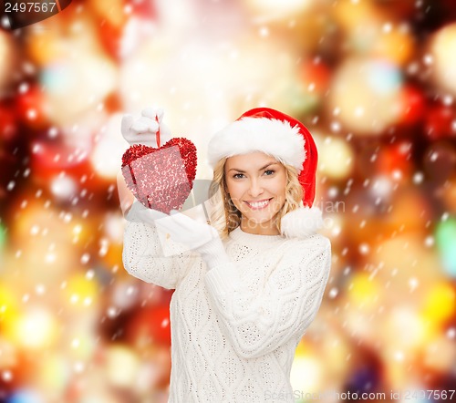 Image of smiling woman in santa helper hat with red heart