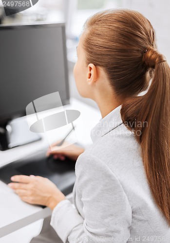 Image of businesswoman with drawing tablet in office