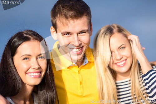 Image of group of friends having fun on the beach
