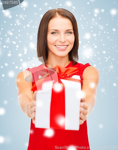 Image of smiling woman in red dress with gift box