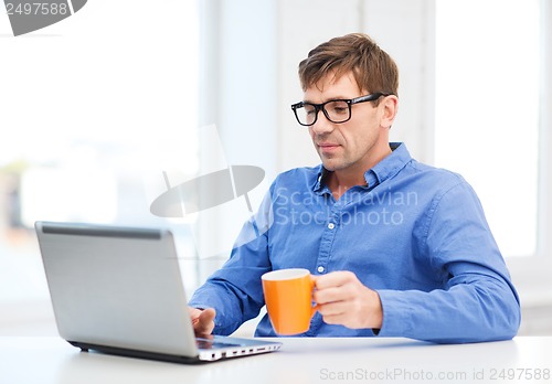 Image of man working with laptop at home