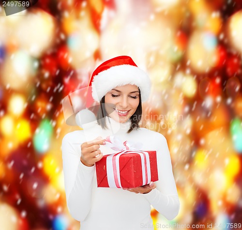 Image of smiling woman in santa helper hat with gift box