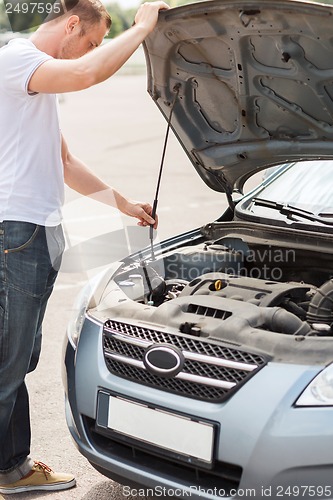 Image of man opening car bonnet