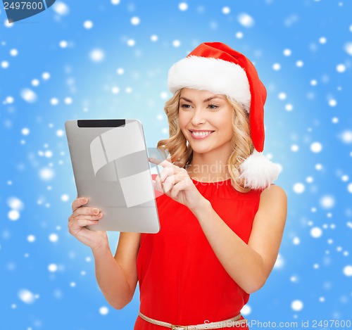 Image of woman in santa helper hat with tablet pc