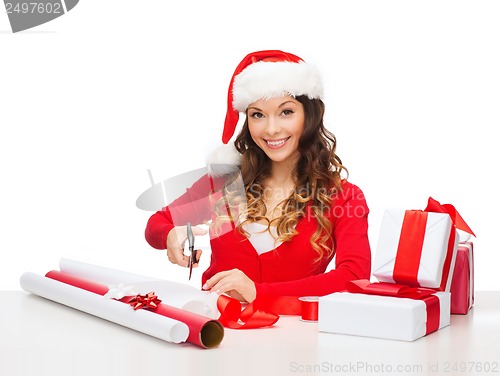Image of smiling woman in santa helper hat with gift box