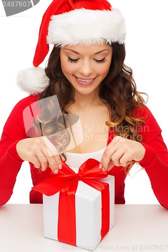 Image of smiling woman in santa helper hat with gift box