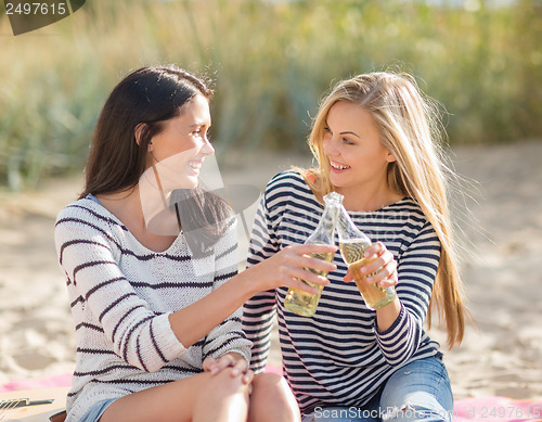 Image of girls with drinks on the beach