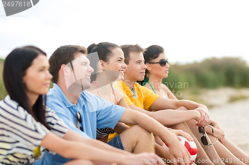 Image of group of friends having fun on the beach