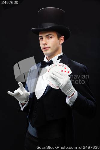 Image of magician showing trick with playing cards