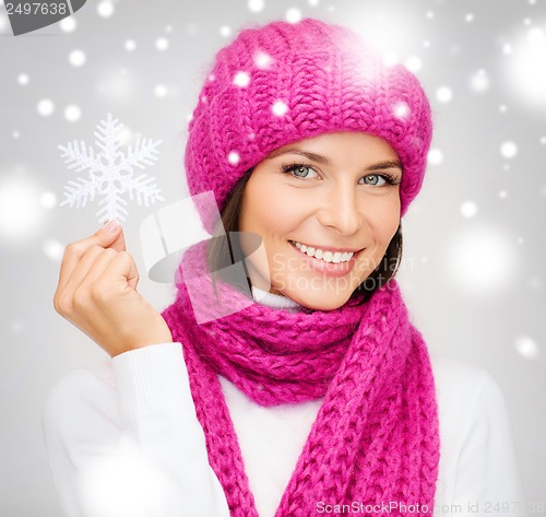 Image of woman in hat and muffler with big snowflake