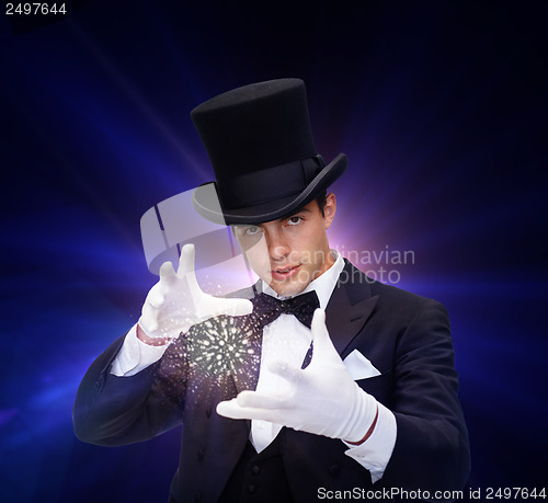 Image of magician in top hat showing trick