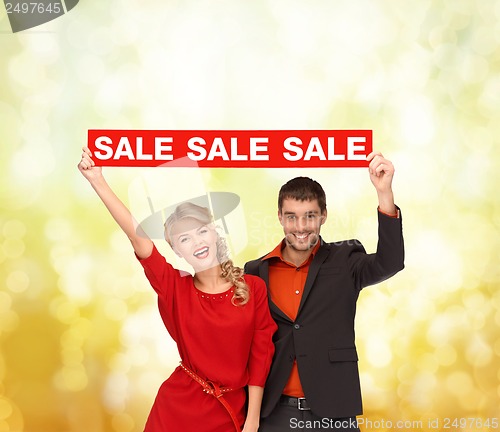 Image of woman and man with red sale sign