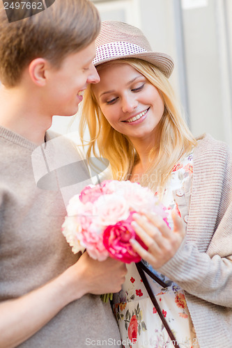 Image of couple with flowers in the city