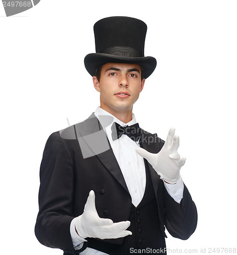 Image of magician in top hat showing trick