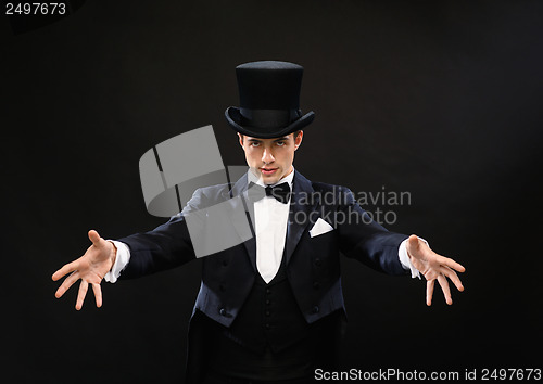 Image of magician in top hat showing trick