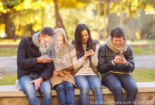 Image of group of friends having fun in autumn park