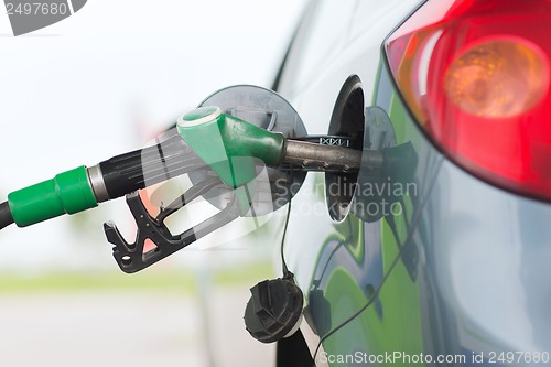 Image of pumping gasoline fuel in car at gas station