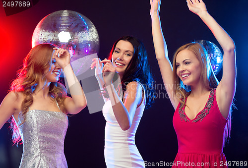 Image of three smiling women dancing in the club