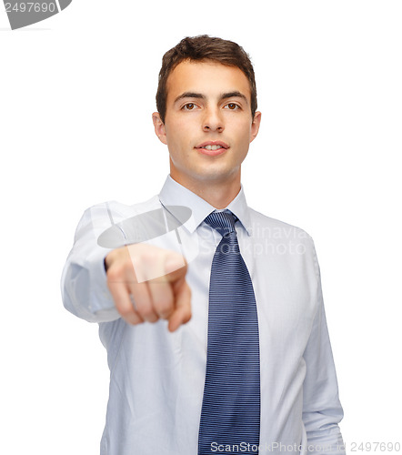 Image of friendly young buisnessman pointing finger